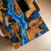 Modern luxury dining room featuring a blue epoxy waterfall table
