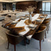 Dining area with a wooden table and chairs in a modern living room.