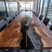 Extra large epoxy river table set in modern boardroom with chairs and décor