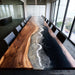 Modern office with extra large epoxy conference table surrounded by chairs