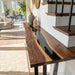 Natural wood and black resin console table in living space with contemporary decor