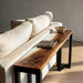 Elegant white epoxy river side table next to a sofa in bright natural light