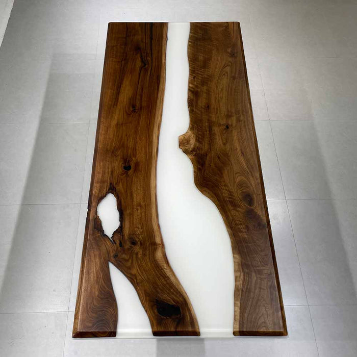 Malibu coastal aesthetic dining table featuring white resin and dark walnut.
