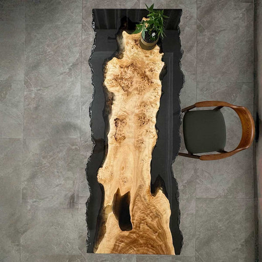 Angled detail shot showcasing the translucent black epoxy river and natural live edge poplar wood craftsmanship of the S72 table.