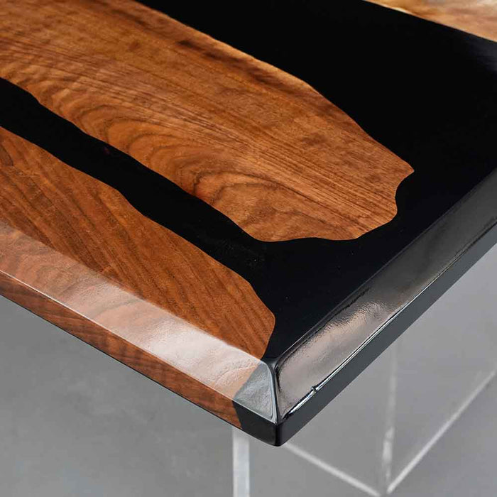 Wooden table with black resin finish on a gray surface