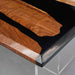Wooden table with black resin finish on a gray surface