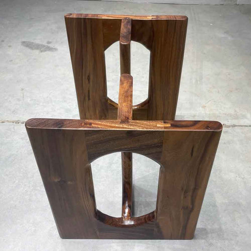 Wooden chair with a unique design on a concrete floor