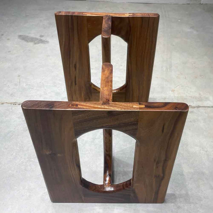 Wooden chair with a unique design on a concrete floor