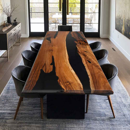 Dining table with black resin inlay surrounded by chairs in a modern room.