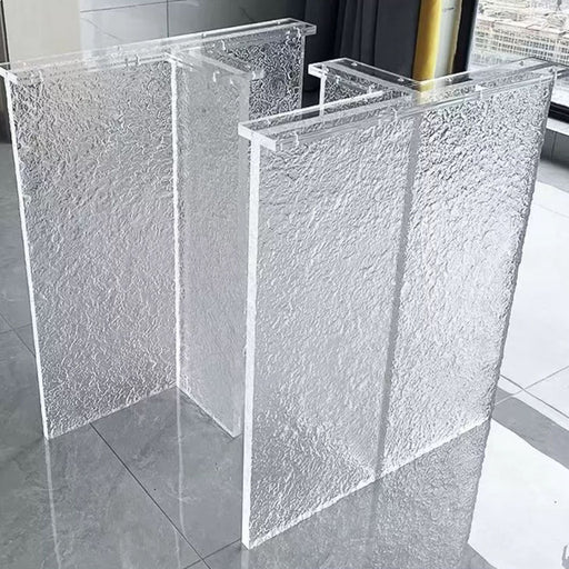 Acrylic T-shaped legs supporting custom river resin and solid wood tables.