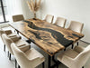 Elegant dining setup featuring an American walnut table with a bold black epoxy river centerpiece.