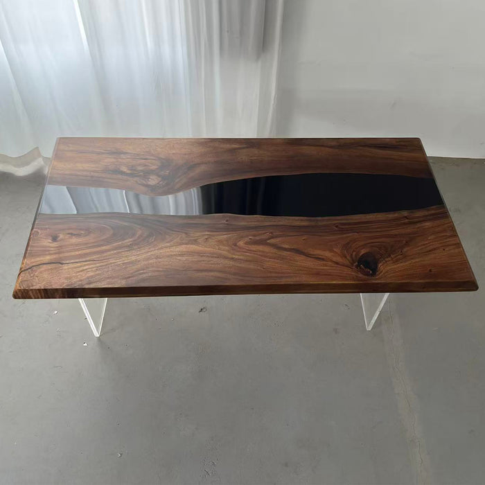 Black epoxy river dining table in a modern kitchen with mountain view.