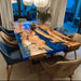 Epoxy dinning table featuring blue resin and olive wood grain