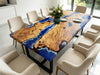Handcrafted golden camphor table with artistic ocean resin detailing and natural wood grain.