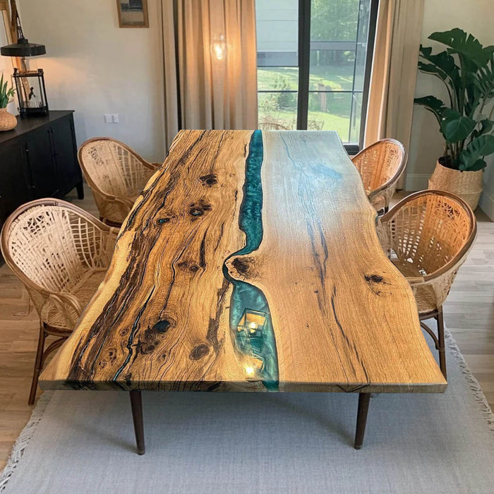 Artisan handcrafted olive wood and blue epoxy river table for modern dining spaces.
