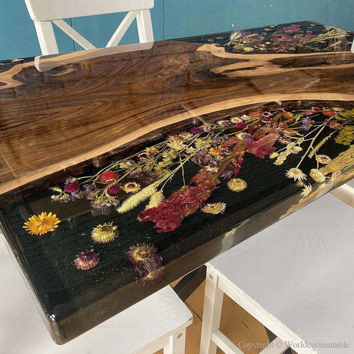 Artisan-crafted walnut epoxy river table showcasing dried flower artwork beneath resin.