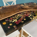 Artisan-crafted walnut epoxy river table showcasing dried flower artwork beneath resin.