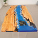 Artistic ocean wave resin table combining natural olive wood and vivid blue epoxy