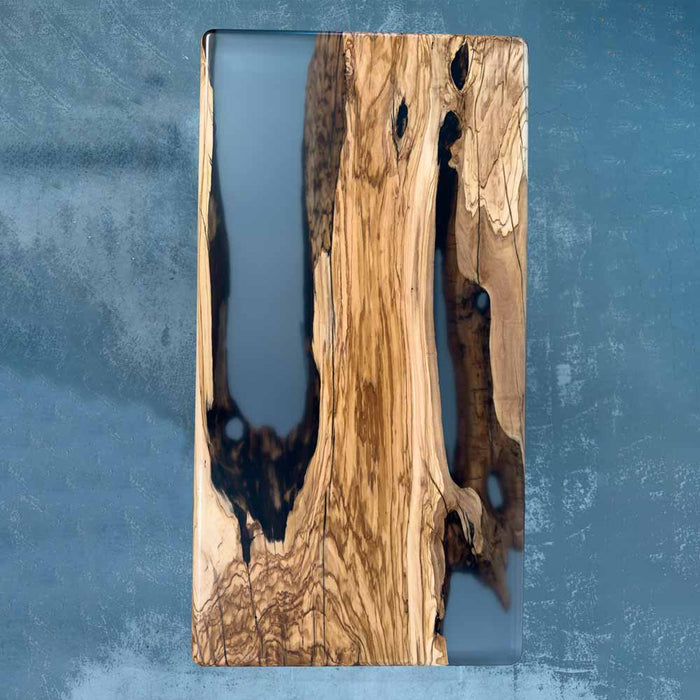 Wooden cutting board with a natural grain pattern on a blue textured background