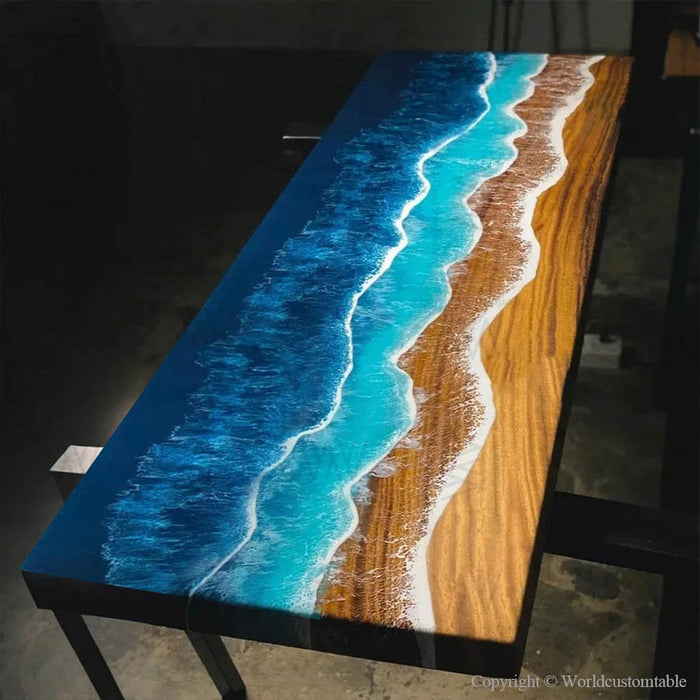 Ocean-style walnut resin table featuring beach sand tones and sculpted resin waves flowing through the river channel.
