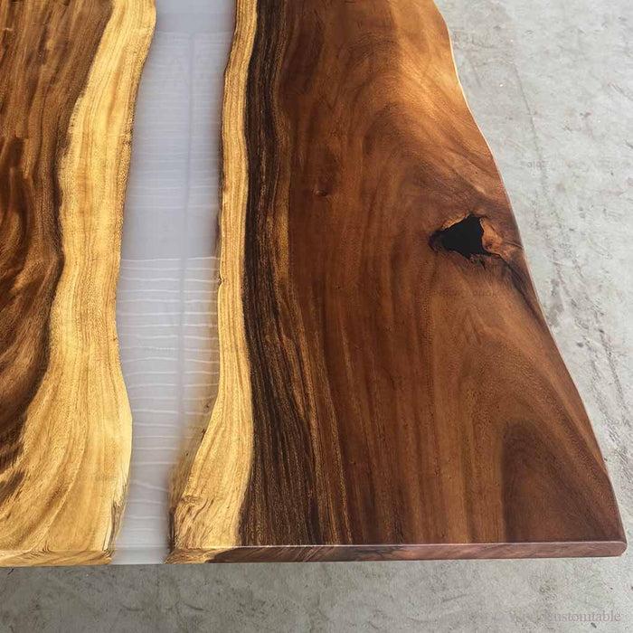 Two wooden slabs with a natural grain pattern on a light gray surface.