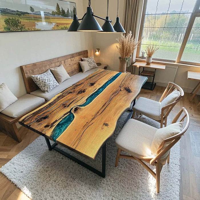 Bespoke olive wood resin dining table with ocean blue epoxy river feature.
