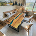 Bespoke olive wood resin dining table with ocean blue epoxy river feature.