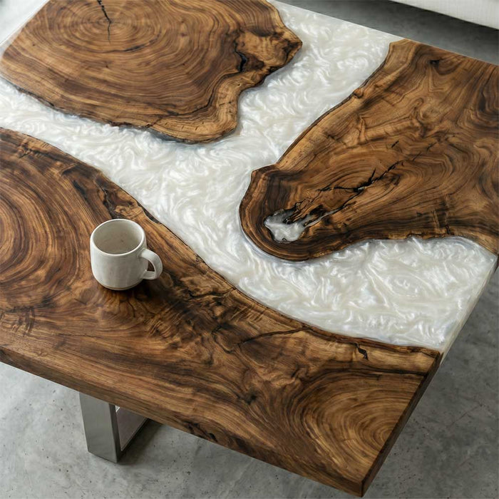 Close-up of the natural wood grain and high-gloss white resin inlay on a custom coffee table.