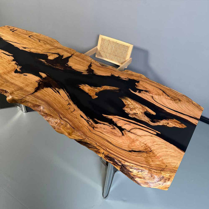 Wooden table with black resin inlay on a gray background