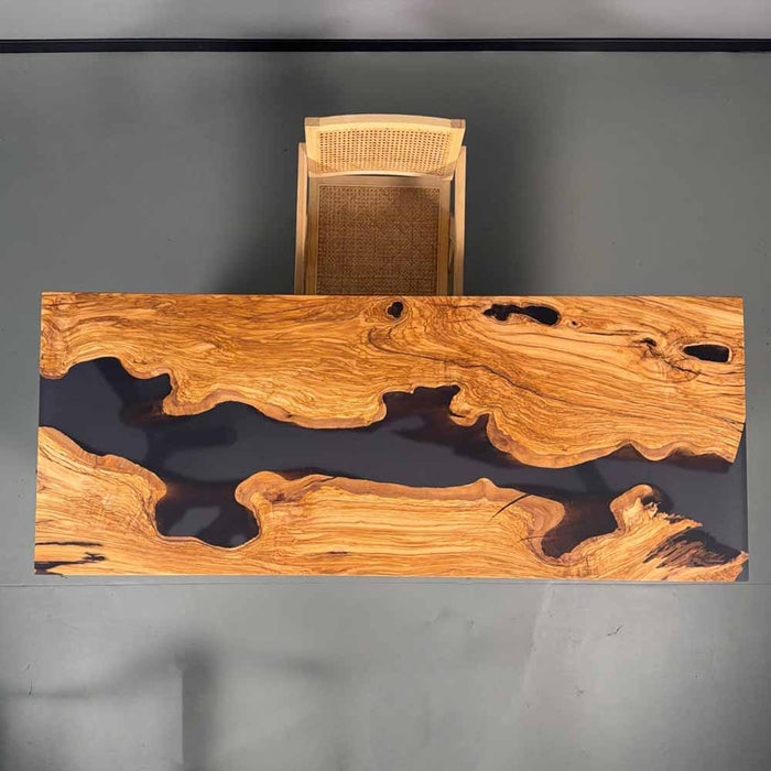 Wooden desk with a wicker chair on a gray background