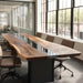 Long wooden conference table with chairs in a modern office setting
