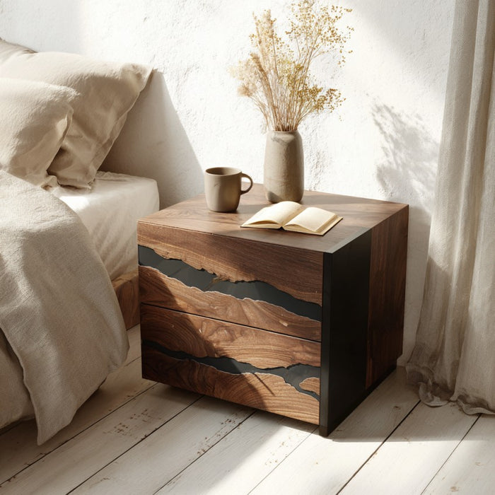 Wooden nightstand with a cup, book, and vase in a bedroom setting