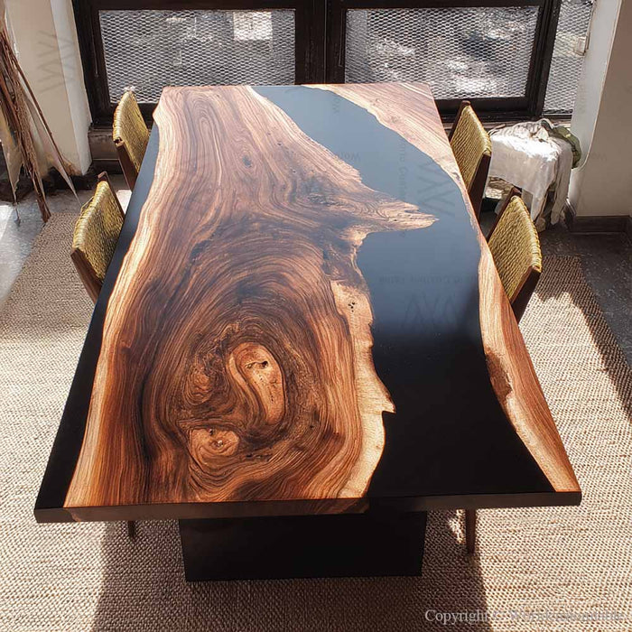 Handcrafted black walnut dining table featuring a deep black epoxy resin river design.