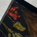 Black walnut live edge table with black epoxy resin and embedded floral design, handcrafted statement dining table