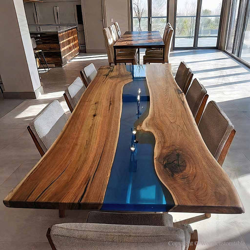 Custom black walnut dining table with deep blue epoxy river and live edge design.