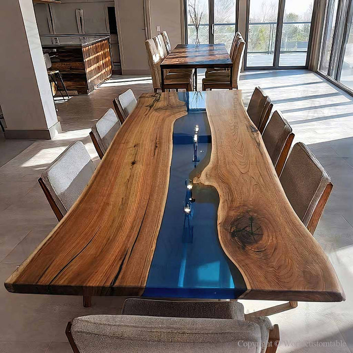 Custom black walnut dining table with deep blue epoxy river and live edge design.