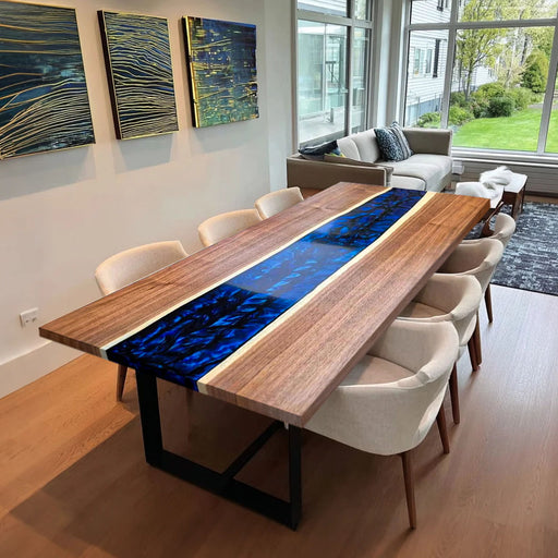 Black walnut dining table with deep blue epoxy river center