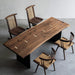 Solid black walnut dining table with butterfly joints and minimalist wood chairs.