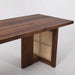 Black walnut dining table with woven rattan leg panels