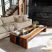 Black walnut epoxy coffee table with waterfall design in a living room by sofa