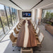 Black walnut epoxy conference table with flowing white resin in modern boardroom