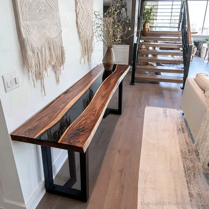 Black walnut epoxy console table in an entryway with decorative accents