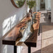 Black walnut epoxy console table placed in a bright hallway interior