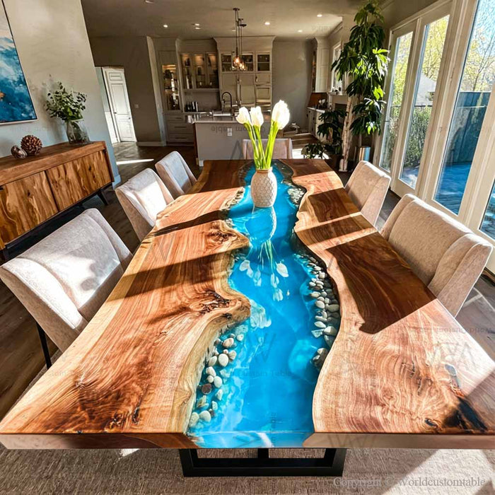 Black walnut epoxy river table with blue resin and stones in dining room
