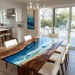 Dining room with a unique table featuring a wood and blue resin design.