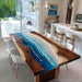 Dining room with a unique wooden table featuring an ocean design.