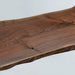 Black walnut natural wood table with irregular shape and flowing grain patterns