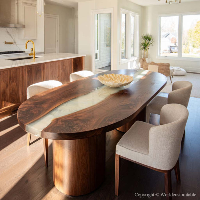 Oval black walnut epoxy dining table placed in a modern farmhouse living room with warm natural lighting