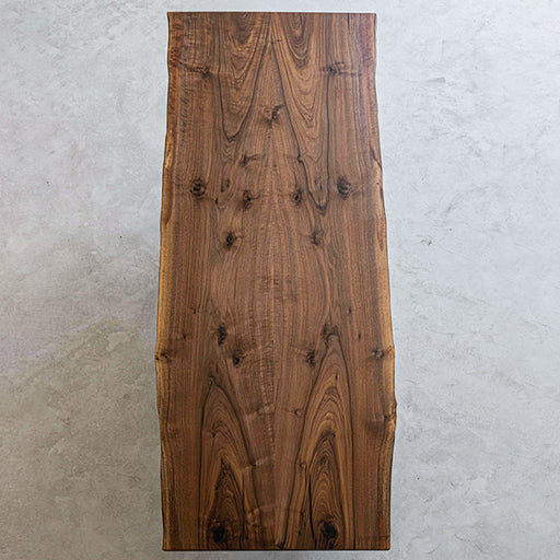 Black walnut solid wood dining table handcrafted to highlight deep wood tones and texture