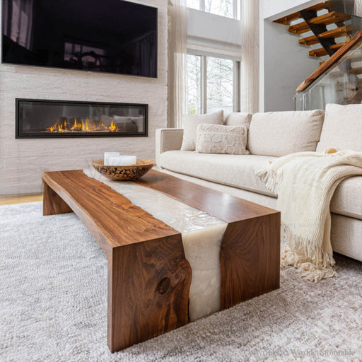 Black walnut epoxy coffee table with white resin waterfall in a living room by sofa